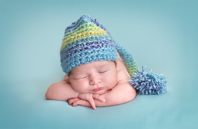 Sleeping Newborn wearing hat - Baby Whispers Photography Royston, Cambridge
