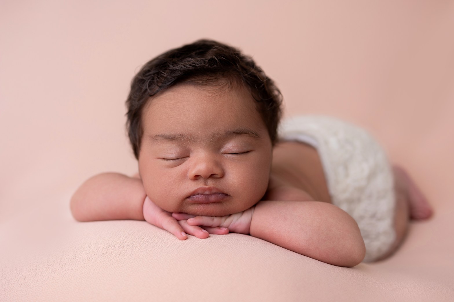 chin on hands newborn pose sleeping baby taken during newborn photoshoot in north hertfordshire near letchworth