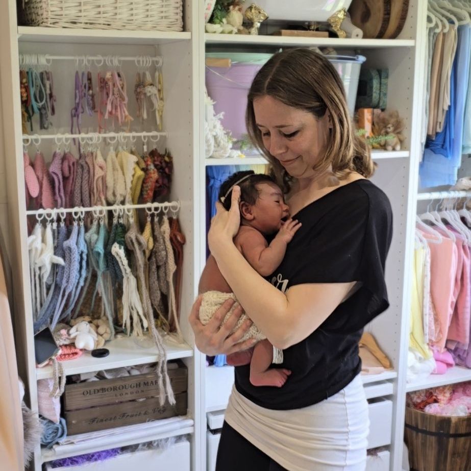rocking sleeping newborn baby in studio